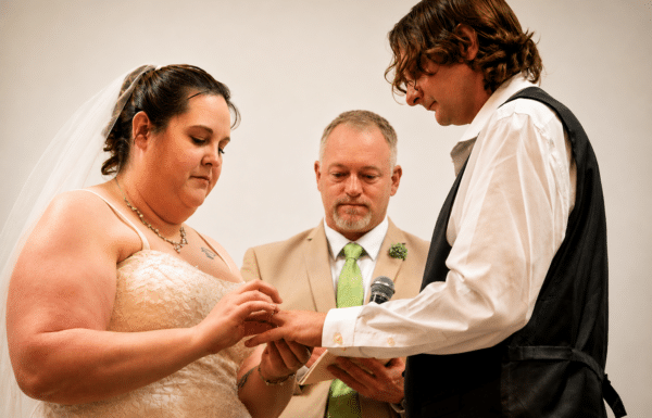 A meaningful ring exchange during a personalized wedding ceremony officiated by Timeless Tributes.